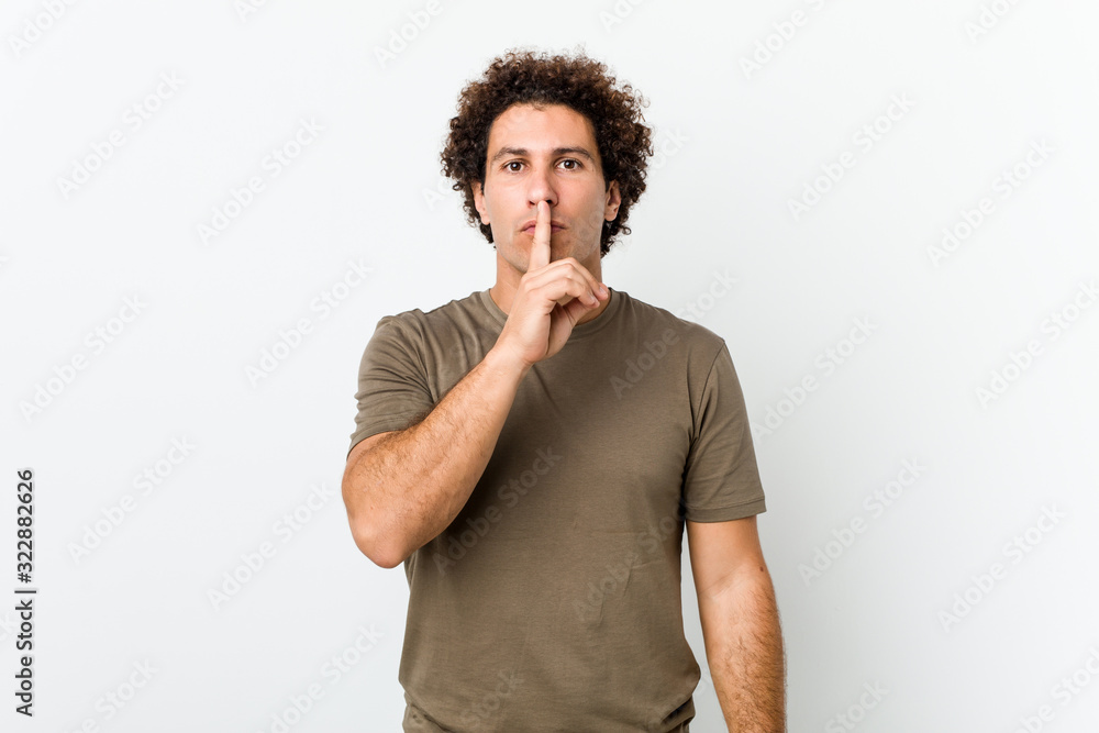 Mature handsome man isolated keeping a secret or asking for silence.