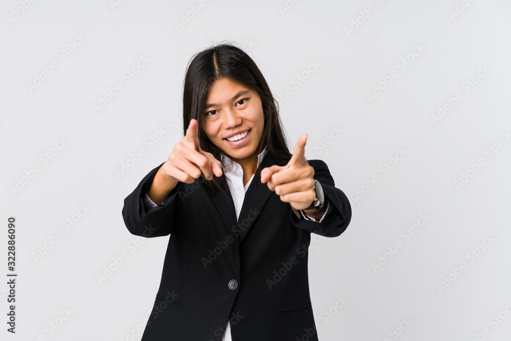 Young asian business woman cheerful smiles pointing to front. Young asian business woman cheerful smiles pointing to front.