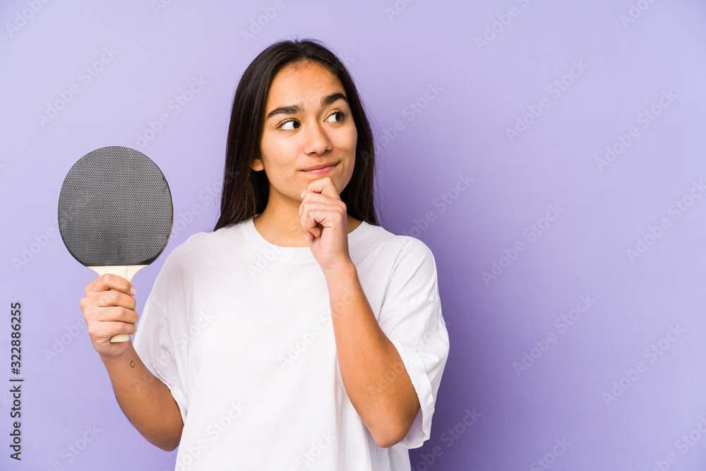 Young indian woman playing ping pong isolated looking sideways with doubtful and skeptical expression. Young indian woman playing ping pong isolated looking sideways with doubtful and skeptical expression.