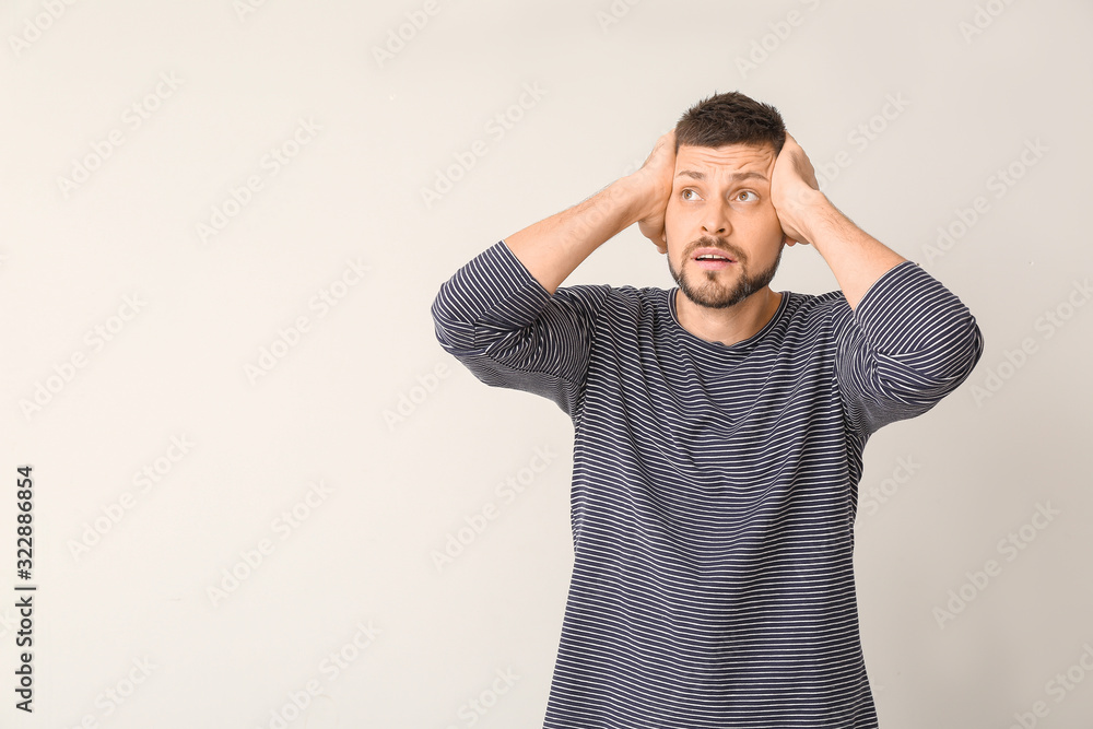 Stressed man on light background. Concept of choice Stressed man on light background. Concept of choice