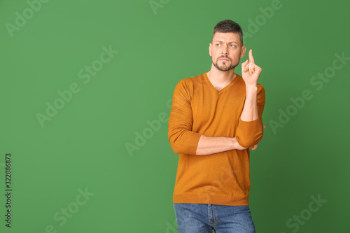 Thoughtful man on color bac...