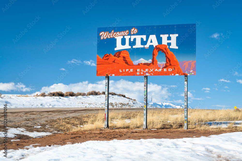 to Utah, elevated life road sign with numerous stickers Stock
