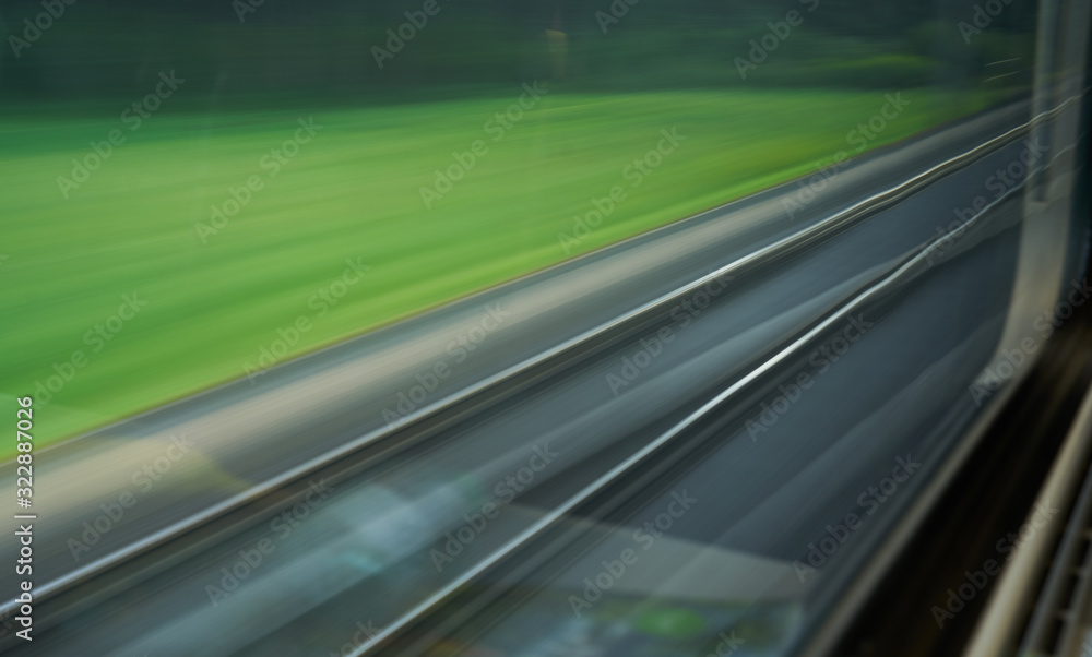 a blurred texture of the railway through the train window