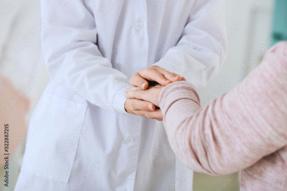 Female doctor with senior woman suffering from Parkinson syndrome in clinic Female doctor with senior woman suffering from Parkinson syndrome in clinic