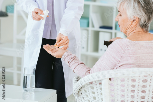 Female doctor giving senior...