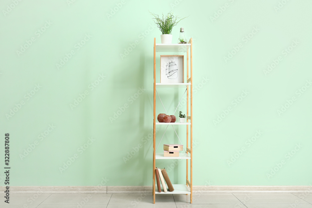 Shelf unit with decor near color wall