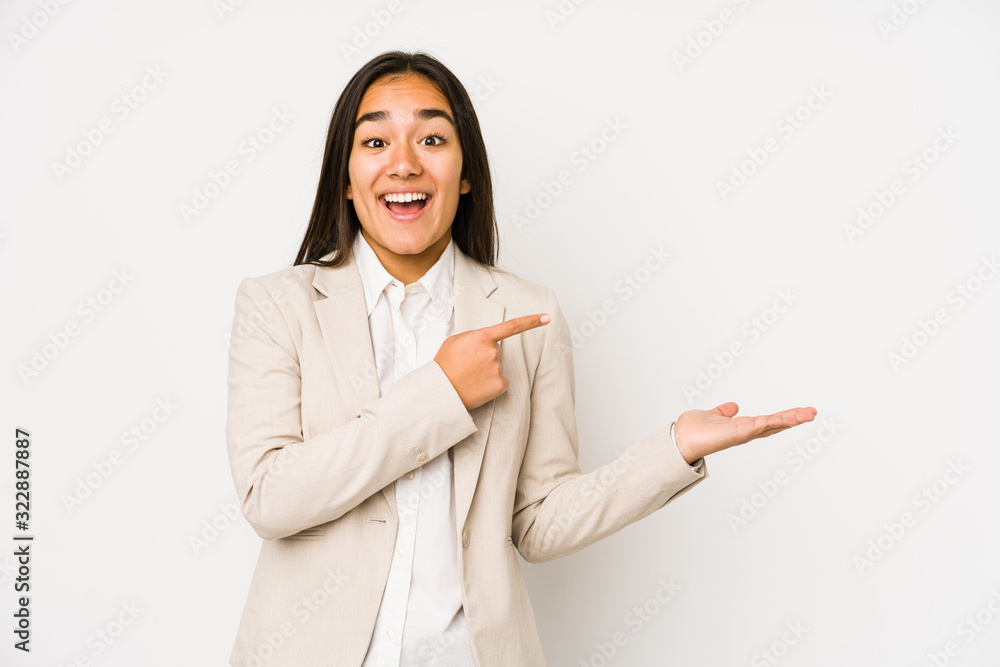 Young woman isolated on a white background excited holding a copy space on palm. Young woman isolated on a white background excited holding a copy space on palm.