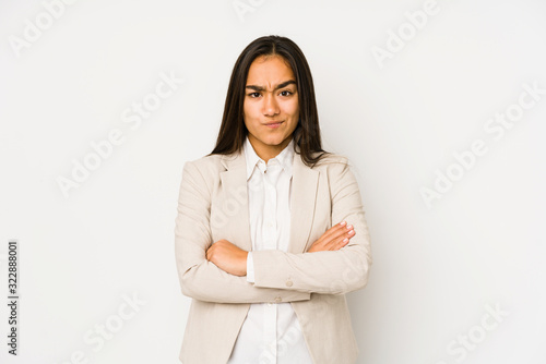 Young woman isolated on a white background frowning face in displeasure, keeps arms folded.