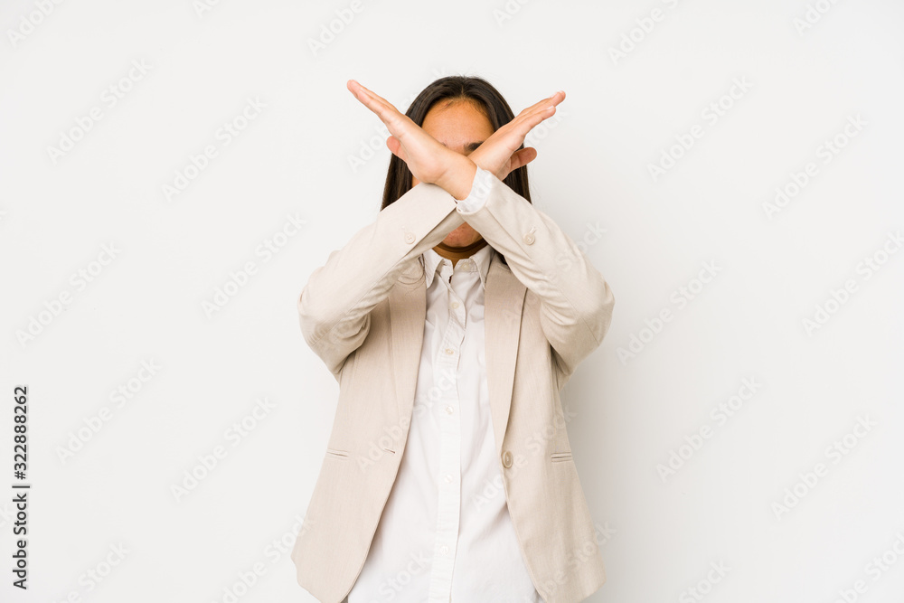 Young woman isolated on a white background keeping two arms crossed, denial concept. Young woman isolated on a white background keeping two arms crossed, denial concept.