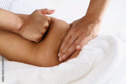 Close up of anti cellulite massage for young woman in wellness center. Perfect skin fat burning beauty concept