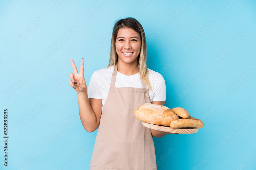 Young caucasian baker woman isolated showing number two with fingers. Young caucasian baker woman isolated showing number two with fingers.