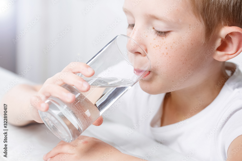 little boy in kitchen drink clean water from glass little boy in kitchen drink clean water from glass
