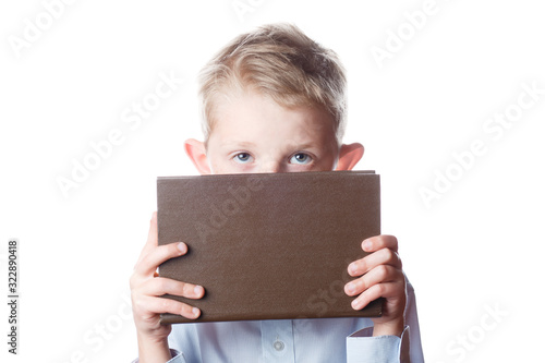 boy hides his face behind a book, portrait © alexxndr