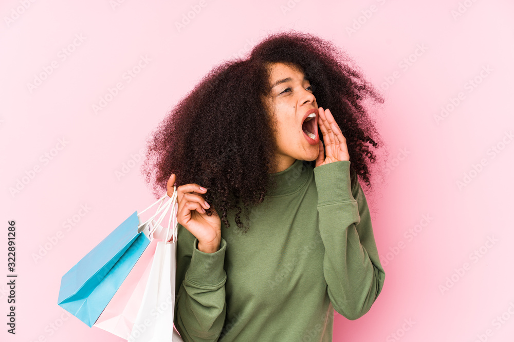 Young afro woman shopping isolated Young afro woman buying isolaYoung afro woman holding a roses isolated shouting and holding palm near opened mouth.< mixto > Young afro woman shopping isolated Young afro woman buying isolaYoung afro woman holding a roses isolated shouting and holding palm near opened mouth.< mixto >