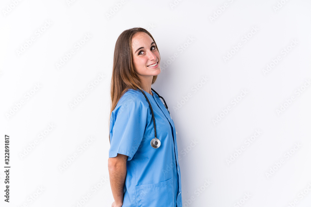 Young nurse woman isolated looks aside smiling, cheerful and pleasant. Young nurse woman isolated looks aside smiling, cheerful and pleasant.