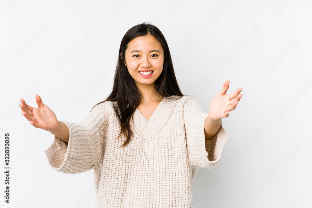 Young chinese woman isolated feels confident giving a hug to the camera. Young chinese woman isolated feels confident giving a hug to the camera.