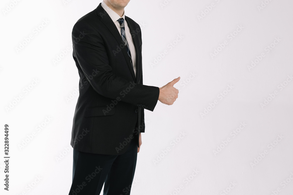 portrait of a businessman standing on a white background. The hand shows the gesture a class portrait of a businessman standing on a white background. The hand shows the gesture a class