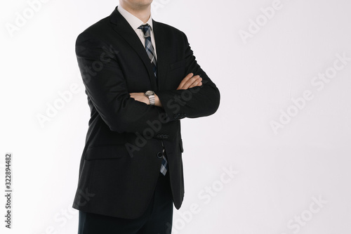 portrait of a businessman standing on a white background with folded hands