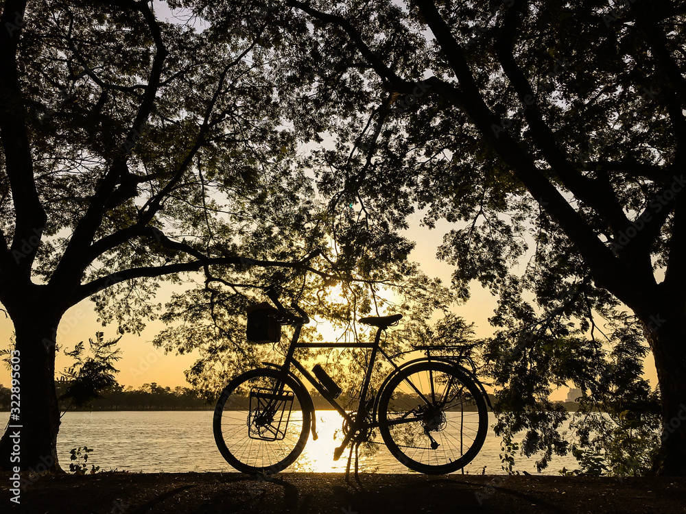 Silhouette of bicycle at sunset background.