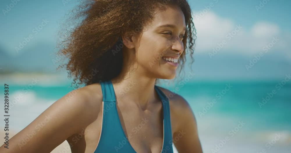 Portrait of a young attractive african american woman smiling and enjoying herself on the beach after her morning workout, Portrait of a young attractive african american woman smiling and enjoying herself on the beach after her morning workout,
