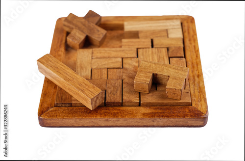 Selective focus. Three-dimensional wooden pentamino board game on a white background. photo