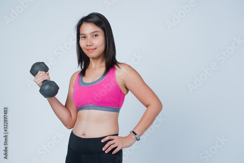 fitness woman lifting dumbbell on white background, girl exercise at morning, workout
