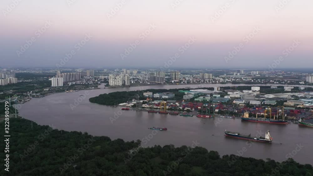 Aerial panning shot of Saigon river and shipping port from high angle at twilight. Ho Chi Minh City is the financial capital of Vietnam Aerial panning shot of Saigon river and shipping port from high angle at twilight. Ho Chi Minh City is the financial capital of Vietnam