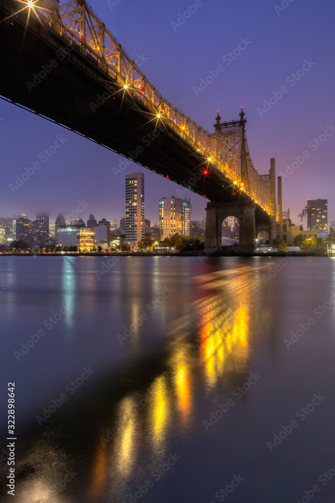 View on Queensboro bridge and Midtown During sunrise from East river with long exposure