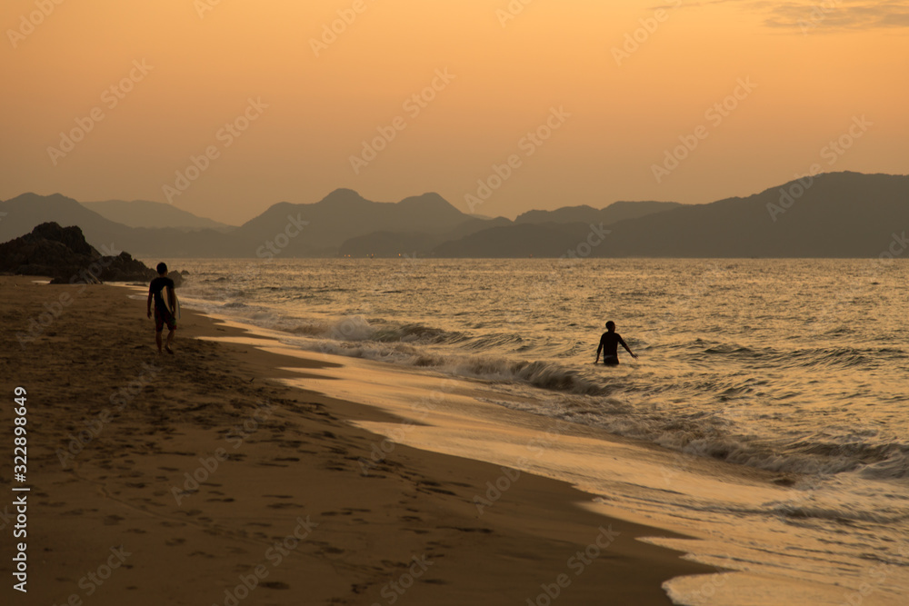 Sunset sea and sandy beach