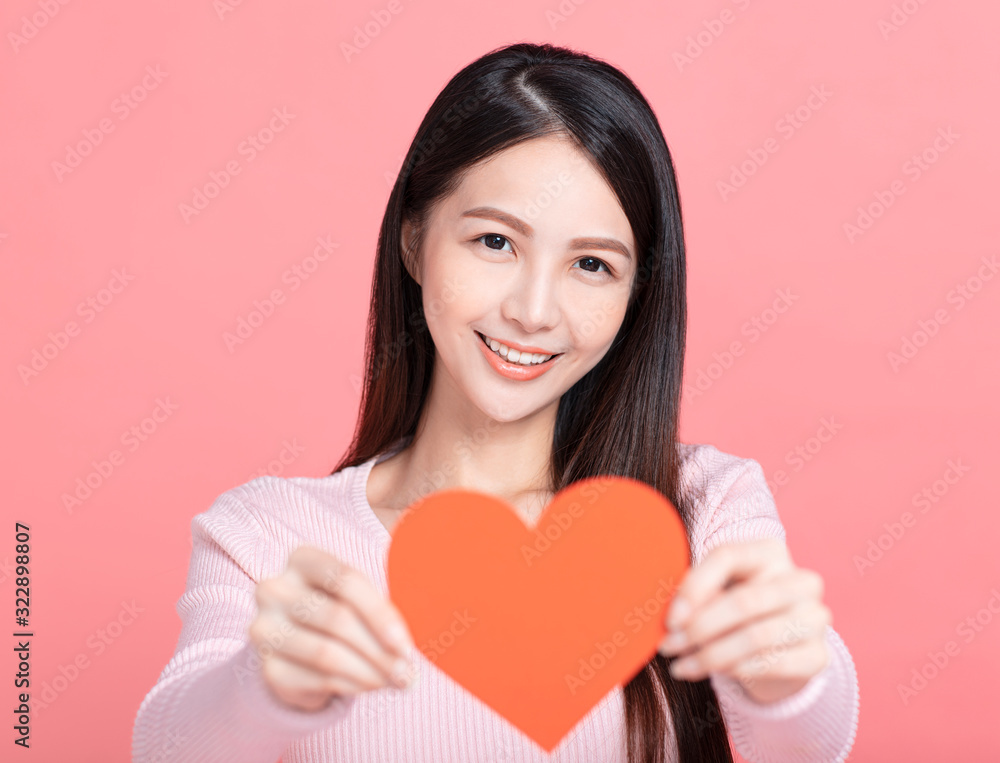 Happy young woman holding red paper hearts and celebrating valentines day Happy young woman holding red paper hearts and celebrating valentines day