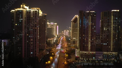 Wallpaper Mural flight over qingdao city downtown night time illuminating show traffic street aerial panorama 4k china Torontodigital.ca