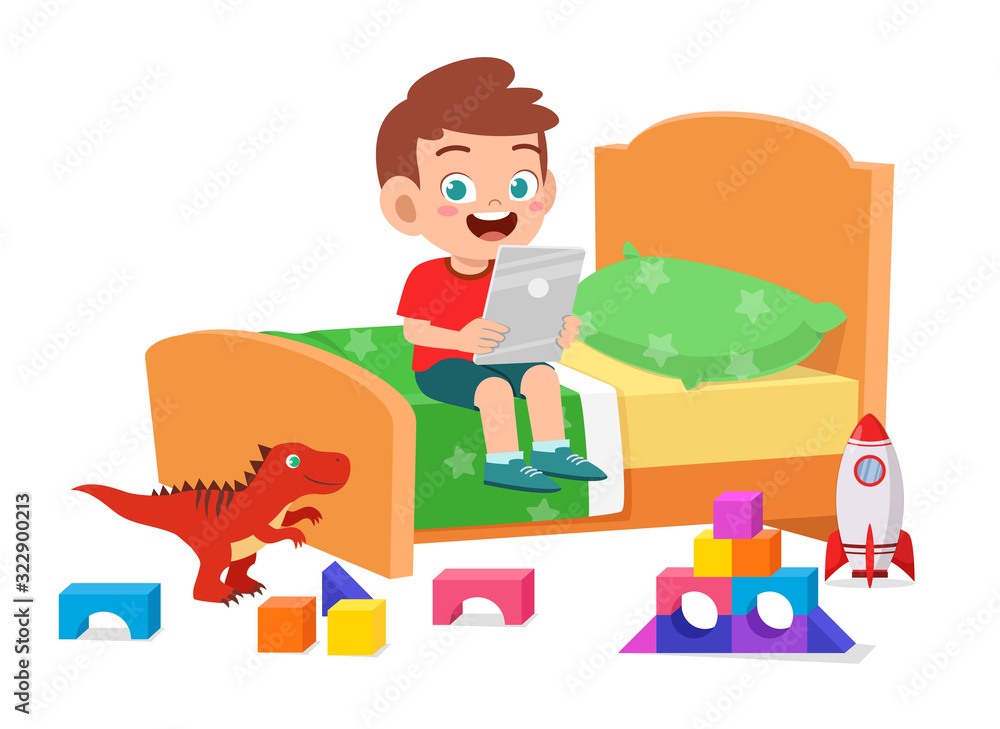 happy cute little kid boy play with tablet in bed room