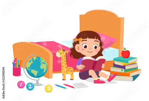 happy cute little kid girl read book in bed room