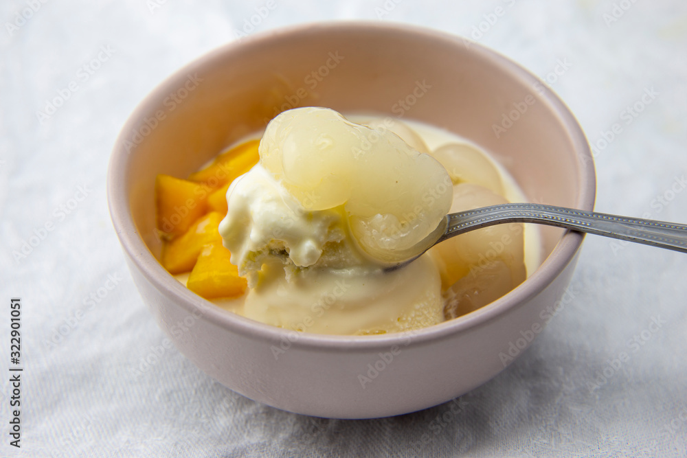 Garnished lychee and mango with vanilla ice cream Garnished lychee and mango with vanilla ice cream