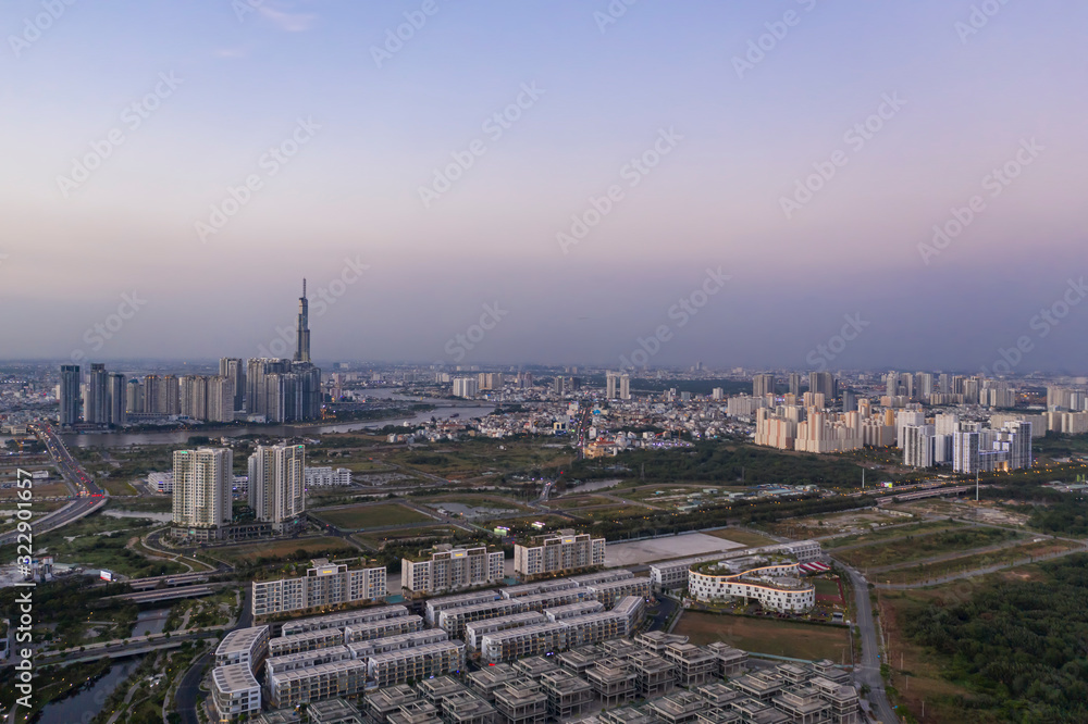 Aerial view to new luxury real estate developments along the Saigon river from Thu Thiem district, in Ho Chi Minh City, Vietnam at twilight