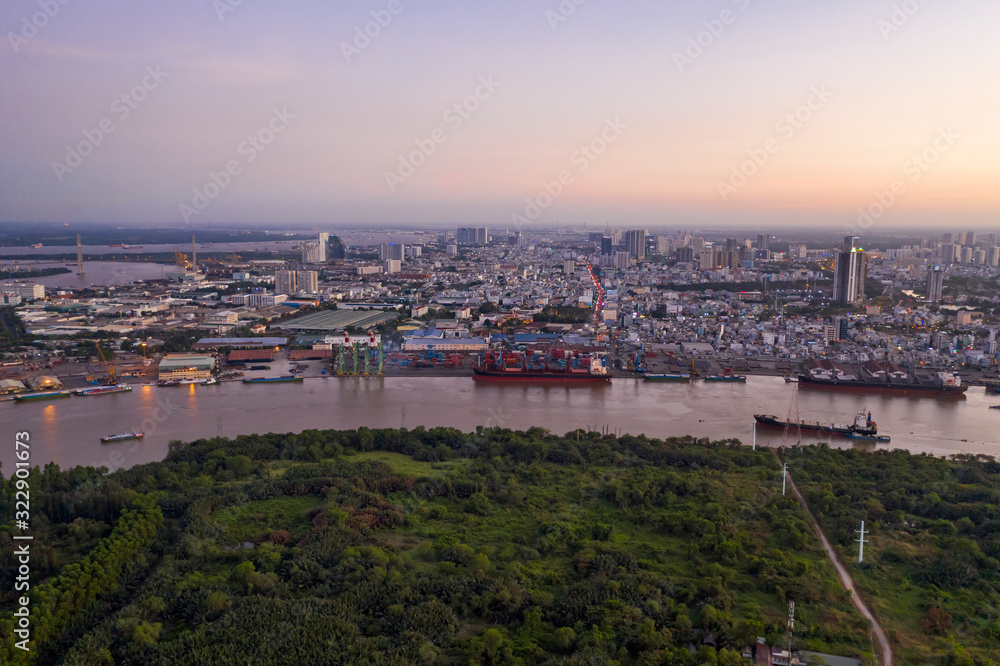 Aerial shot of Saigon river and shipping port from high angle at twilight. Ho Chi Minh City is the financial capital of Vietnam