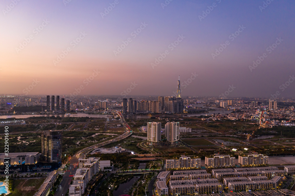 Aerial view to new luxury real estate developments along the Saigon river from Thu Thiem district, in Ho Chi Minh City, Vietnam at twilight