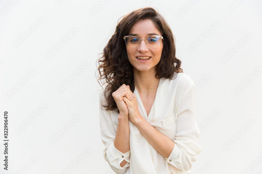 Front view of smiling young woman in eyeglasses. Cheerful curly lady looking at camera. Female beauty concept Front view of smiling young woman in eyeglasses. Cheerful curly lady looking at camera. Female beauty concept