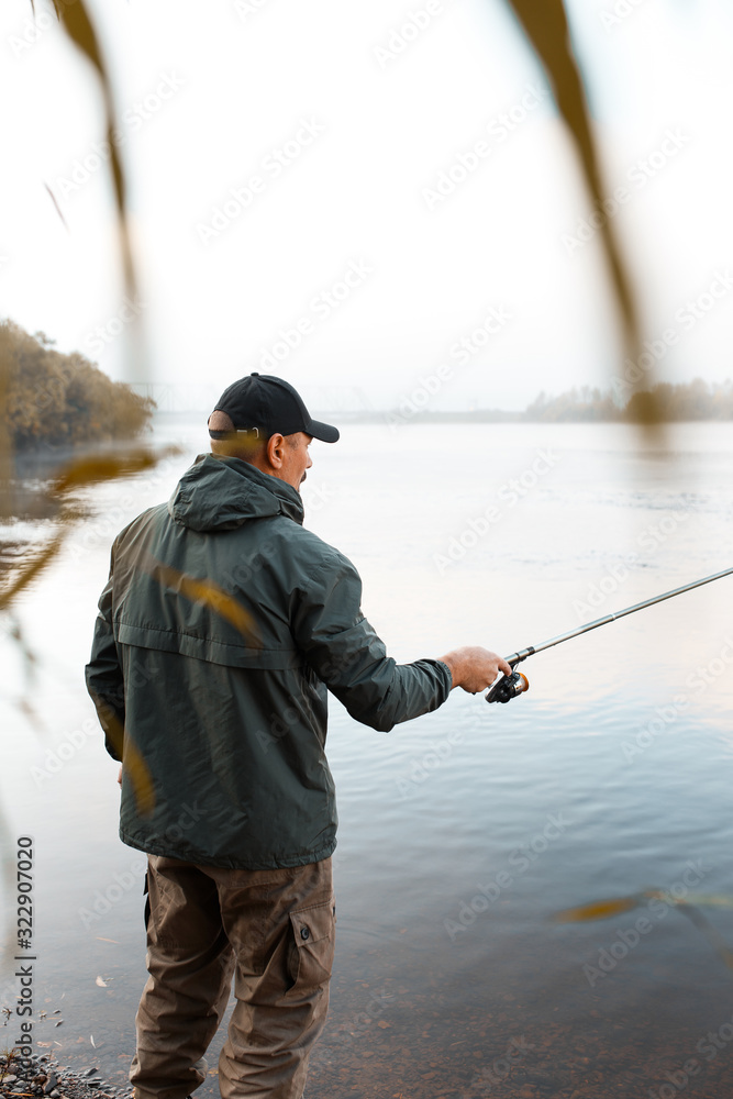 A man is fishing on the river. Fisherman on a morning fishing trip A man is fishing on the river. Fisherman on a morning fishing trip