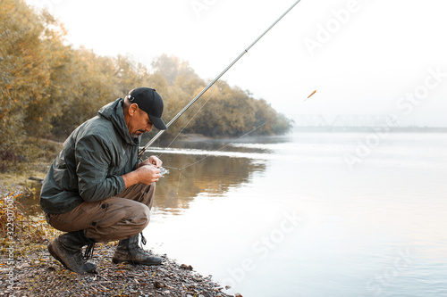 A man is fishing on the river. Fisherman on a morning fishing trip