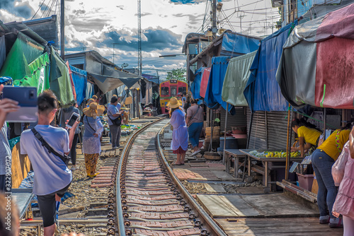 Photography Tourists take photo at the train running through the most popular spot Talad Rom