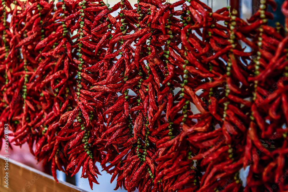 Close up view of hanging hot dried chili peppers on the local farmers market Mercado dos Lavradores in Funchal Madeira