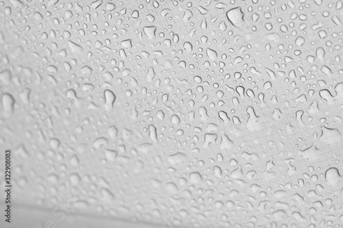 Water​ rain​ drops​ on​ white fabric tent​s background