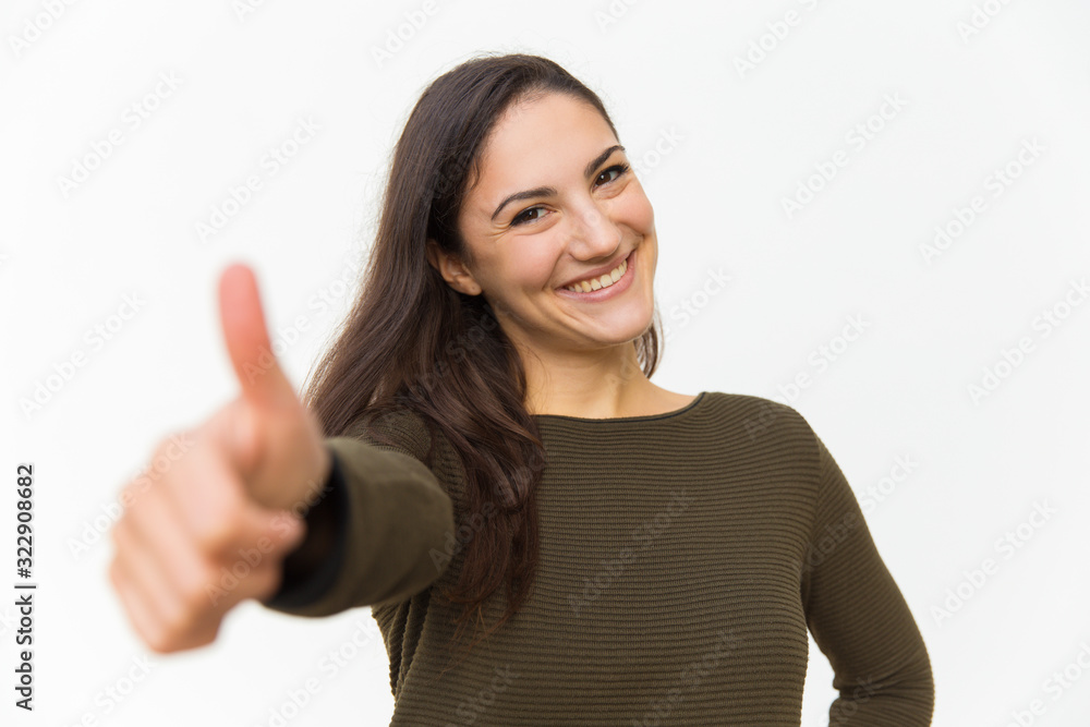 Beautiful smiling woman showing thumb up. Cheerful lady looking at camera and gesturing. Approving, ok concept Beautiful smiling woman showing thumb up. Cheerful lady looking at camera and gesturing. Approving, ok concept
