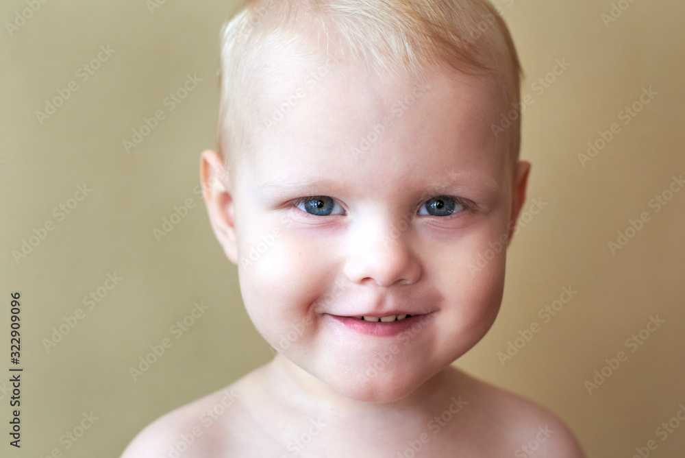 Portrait of a little blue-eyed fair-haired smiling boy of two years old. Portrait of a little blue-eyed fair-haired smiling boy of two years old.