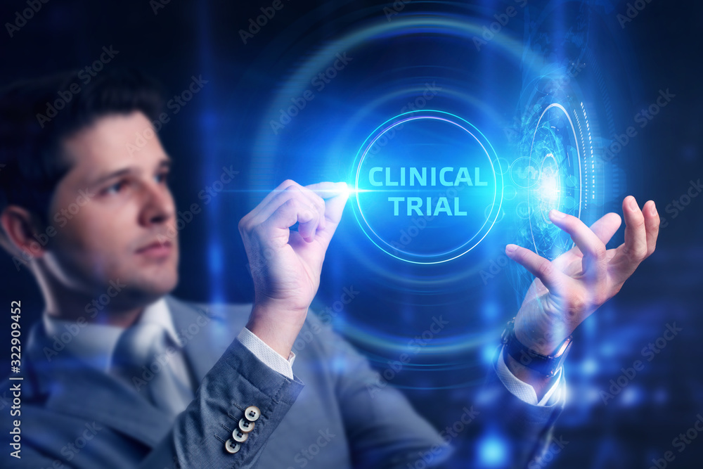 Business, Technology, Internet and network concept. Business man working on the tablet of the future, select on the virtual display: Clinical trial Business, Technology, Internet and network concept. Business man working on the tablet of the future, select on the virtual display: Clinical trial