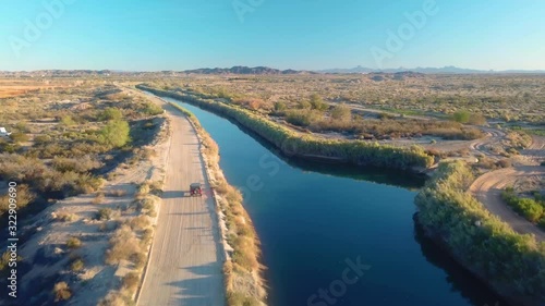 Drone aerial view of vehicle driving along the Gila Gravity Canal - Yuma Arizona