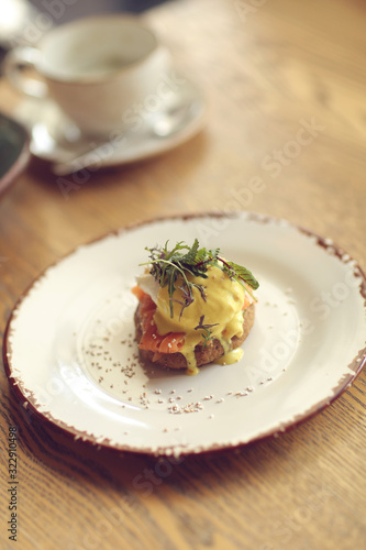 open sandwich with light-salted salmon and poached egg and avocado