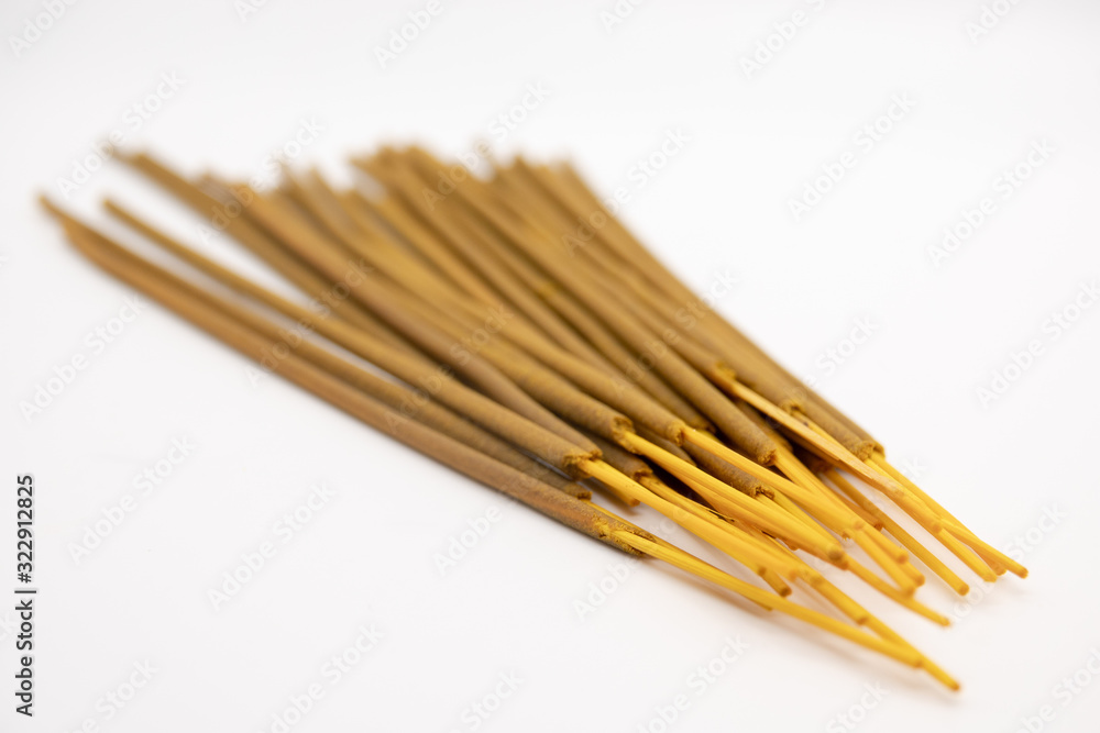 Brown indian incense aroma sticks isolated on white background close up. Set of buddhist incense stick for meditation top view Brown indian incense aroma sticks isolated on white background close up. Set of buddhist incense stick for meditation top view