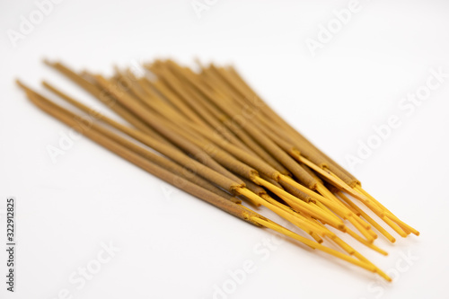 Brown indian incense aroma sticks isolated on white background close up. Set of buddhist incense stick for meditation top view